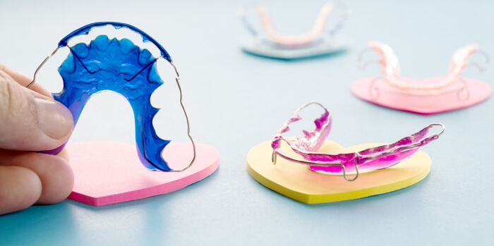 Four different colored retainers